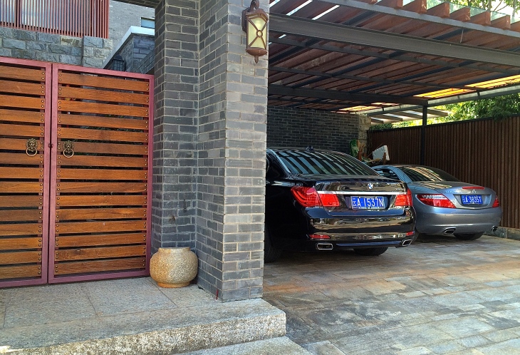 One of our neighbors with their BMW and Mercedes in the carport.