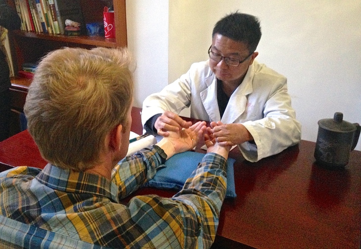 Traditional Chinese doctor preparing to "check my pulse" (bamai)